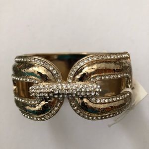 Gold plated wrist cuff with clear stones.